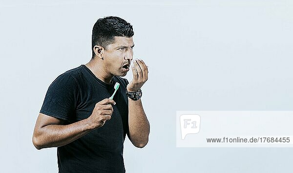 Person with brush with bad breath problem  Man with brush and bad breath  Concept of person with halitosis