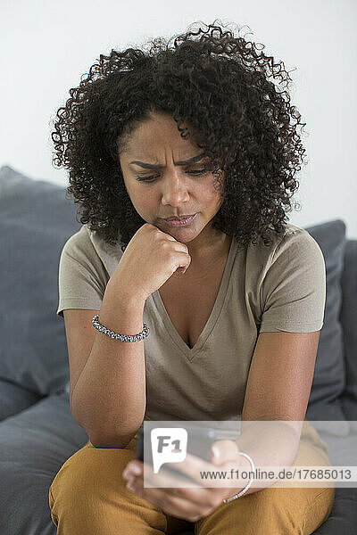 Woman reading message on smart phone