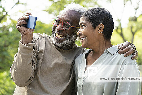 Smiling couple taking selfie with smart phone