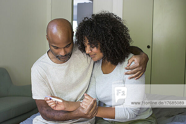 Couple holding pregnancy test kit