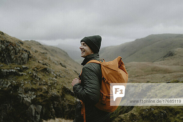 Portrait happy male hiker with backpack in rugged landscape  Great End  England