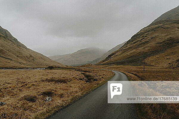 Cracked road through landscape in tranquil Scottish Highlands  Glenfinnan  Scotland