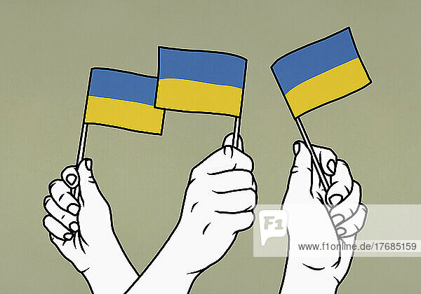 Hands waving Flags of Ukraine