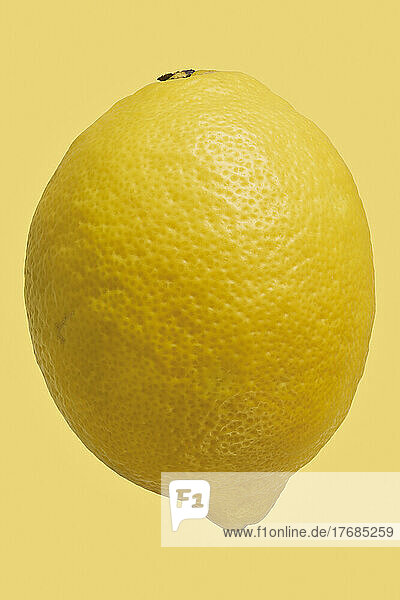 Close up dimples on vibrant  whole yellow lemon