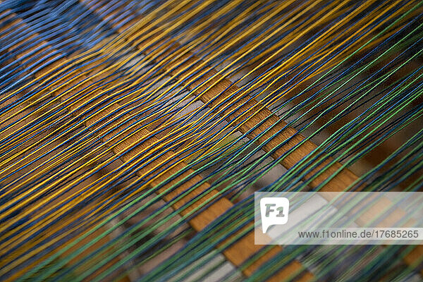 Close up green and yellow thread on loom