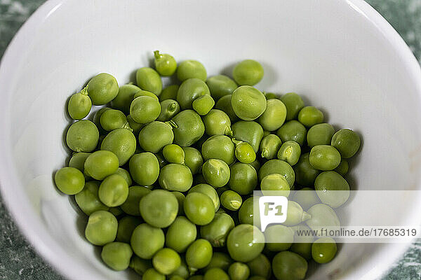 Close up organic green peas in bowl