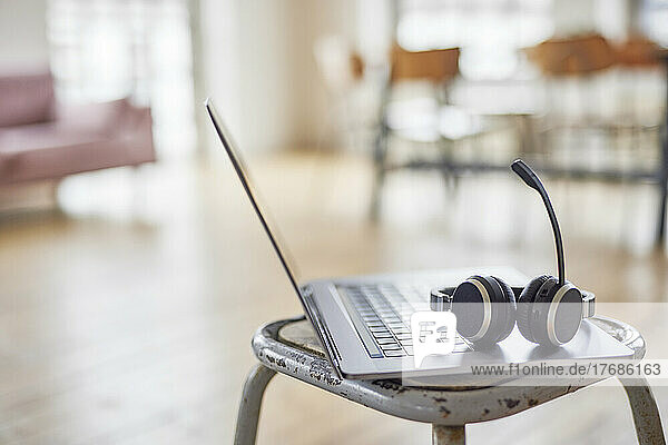 Headset on laptop on stool