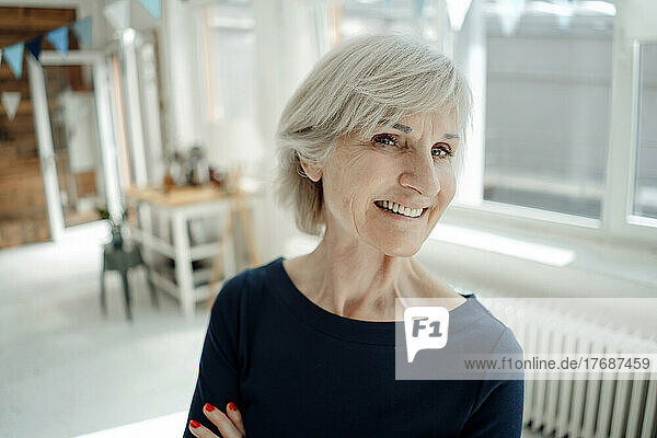 Smiling businesswoman with gray hair in office