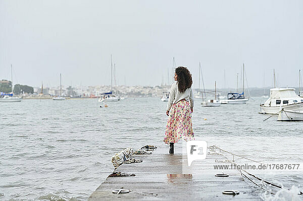 Woman with long hair standing on jetty