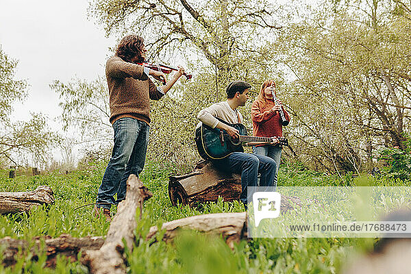 Musicians playing musical instruments in field