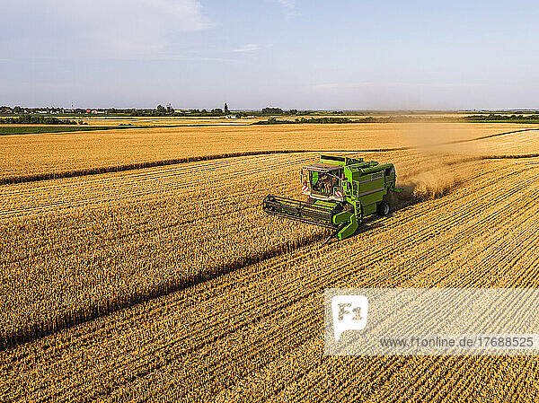 Combine harvester at agricultural field on sunny day