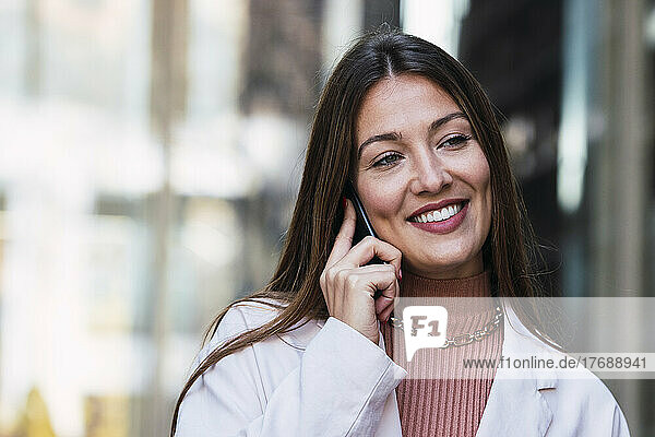 Happy woman talking on mobile phone