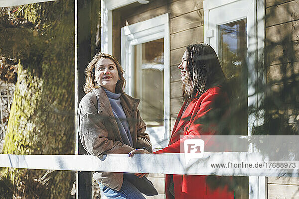 Young women standing in patio on sunny day