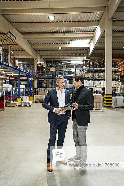 Mature businessmen discussing in meeting at factory