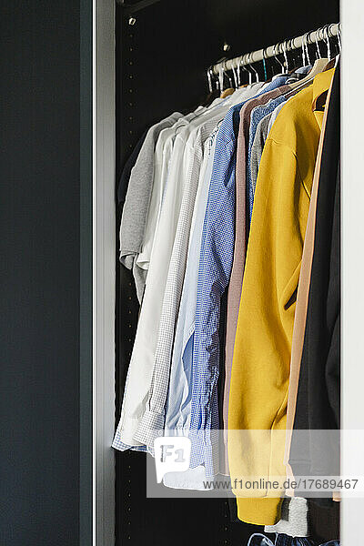 Clothes arranged in closet at home