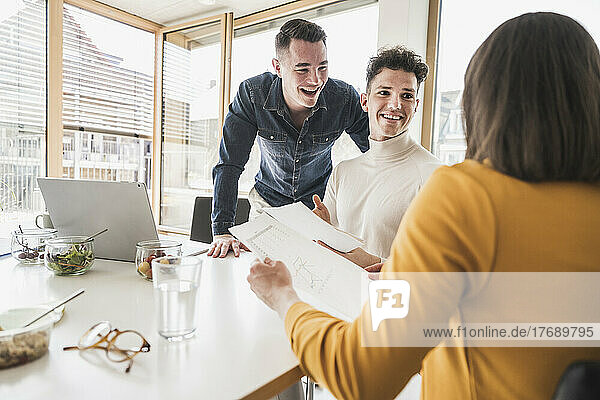 Happy young business people during a meeting in office