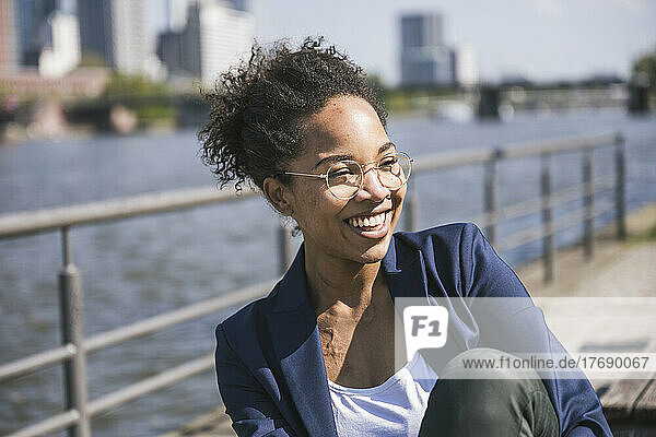 Young businesswoman laughing on sunny day