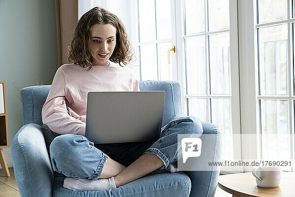 Businesswoman using laptop working at home