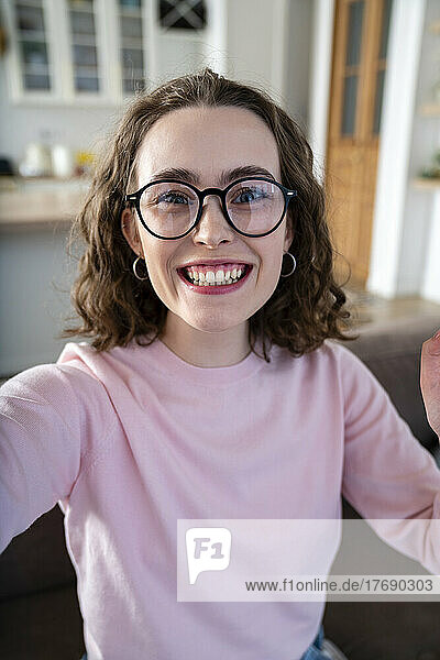 Cheerful woman with eyeglasses at home