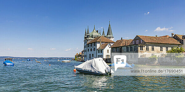 Switzerland  Thurgau  Steckborn  Shrink wrapped boats floating near shore of Lake Constance with town houses in background