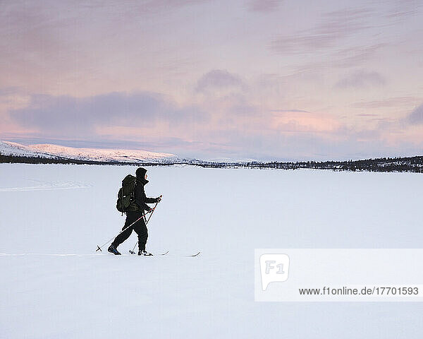 Woman cross-country skiing on Lake Grovelsjon in Rogen Nature Reserve  Sweden