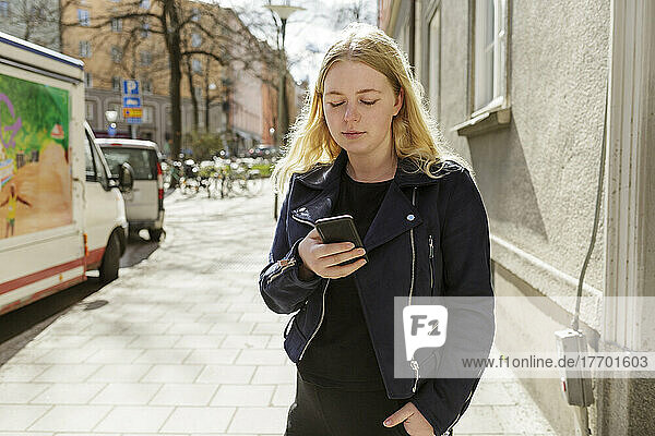 Young woman using smart phone in Stockholm  Sweden