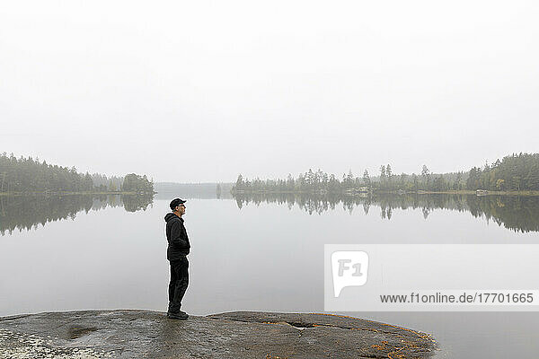 Man standing by Stora Skiren Lake  Sweden
