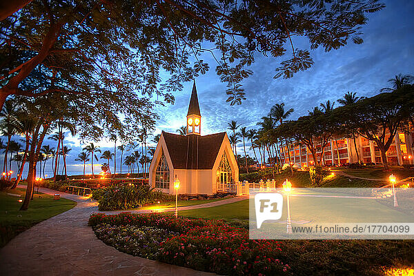 Glowing lights illuminate the Chapel by the Sea at the Grand Wailea Resort in Wailea  Maui  Hawaii  USA at sunset; Wailea  Maui  Hawaii  United States of America