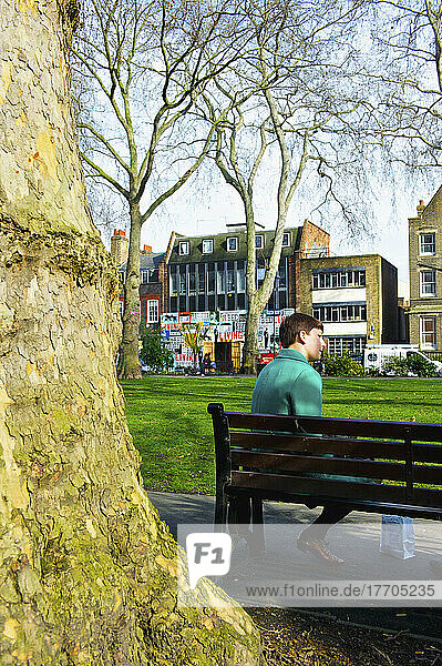 Sitting On A Park Bench In An Urban Park  Shoreditch; London  England