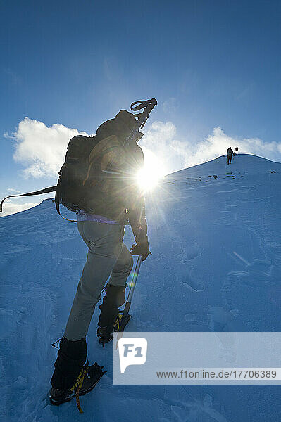 Wanderer beim Klettern an den verschneiten Hängen von Sgorr Dhearg in der Nähe von Glen Coe; Highlands  Schottland
