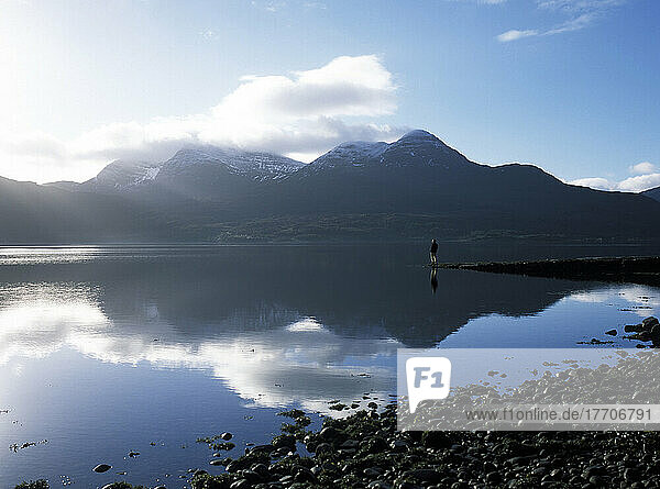 Man Standing On End Of Pier Beside Loch Torridon On A Calm Morning  Ross-Shire  Scotland.