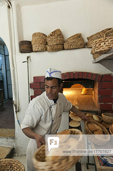 A Baker Prepares The Oven-Baked Bread For Delivery  Al-Saraya Restaurant; Madaba  Jordan