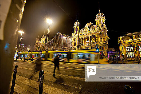 Tram And People Crossing In Front Of Budapest Western Railway Station At Night  Budapest  Hungary
