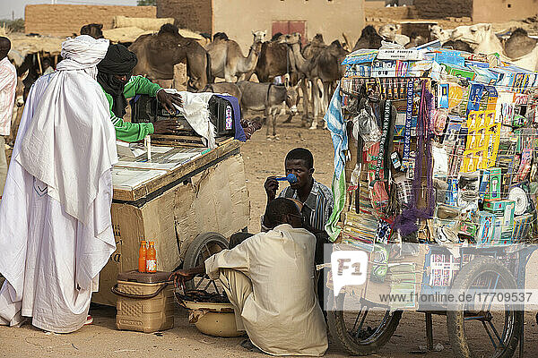 Niger  Tuareg-Männer beim Einkaufen von Kleidungsstücken am Stand eines Housa-Händlers. Der Viehmarkt von Agadez; Agadez