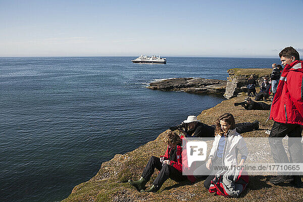 Tourists On Shore With A Cruise Ship Off The Coast; Svalbard  Norway