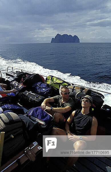 Travellers On Ferry Leaving Ko Phi Phi Don Islanad. 'the Beach' Ko Phi Ley In Background. Heading To Southern Thailand