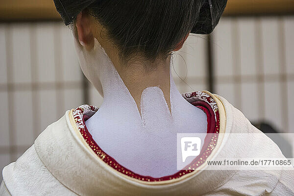 Body paint on the back and neck of teenage girl  a Maiko  apprenticing to be a Geisha. Maiko are usually aged between 17 to 20 years old  and graduate to geisha status after a period of training  which includes learning to dance traditionally  play the shamisen  sing kouta (lit. short songs )  and  in Kyoto only  learn the Kyoto dialect. This apprenticeship usually ranges from a period of a few months to a year or two years  though apprentices too old to dress as maiko may instead skip to the stage of geisha  despite still being in training; Kyoto  Japan