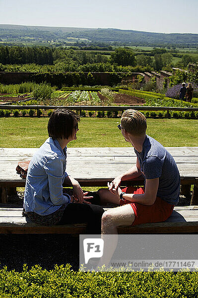 A Couple Sits Enjoying The View Of Barley Wood Walled Garden; Wrington  England