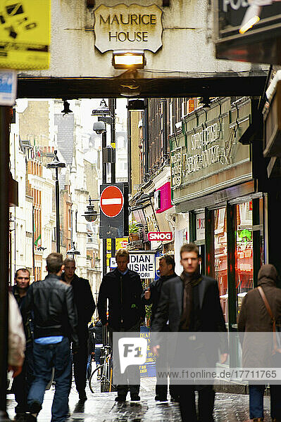 Pedestrians On A Busy Street In Soho; London  England