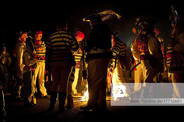 People Collecting Around Small Fire During A Break In Procession At East Hoathly Bonfire Night; East Sussex  England