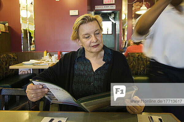 Woman Looking At Menu In Restaurant  Toronto  Ontario