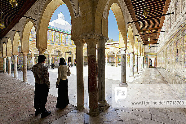 A Young Couple Stand On The Threshold Of The First Court Inside The Barber's Mosque; Kairouan  Tunisia  North Africa