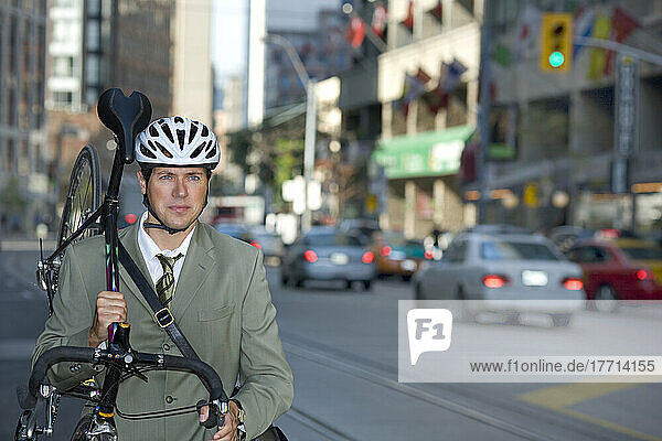 Geschäftsmann hält sein Fahrrad auf der Straße  Toronto  Ontario