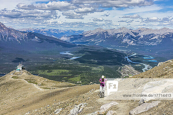 Woman hiking on The Whistlers mountain summit near the Skytram Upper Station in the Canadian Rockies of Jasper National Park; Alberta  Canada