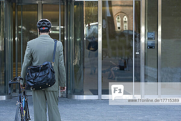 Businessman With Bicycle Going In To Office Building  Toronto  Ontario