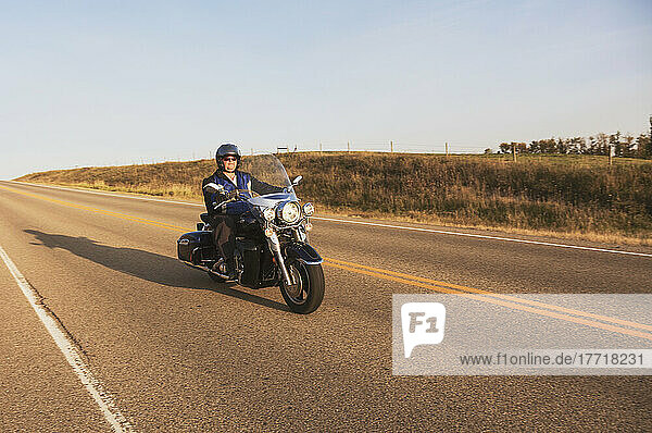 Mature Man Riding A Motorcycle On Highway; Edmonton  Alberta  Canada