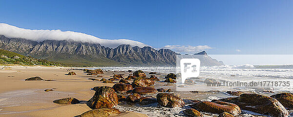 Felsenstrand am Atlantischen Ozean bei Kogel Bay mit den Kogelbergen im Hintergrund; Kogel Bay  Westkap  Südafrika
