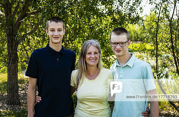 Outdoor portrait of a mother with two sons; Edmonton  Alberta  Canada