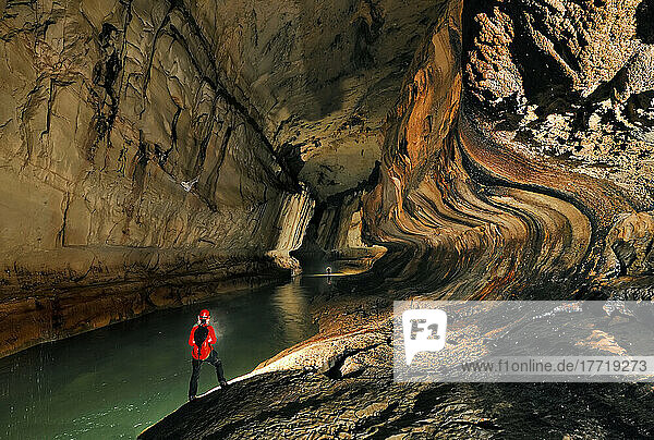 A Mulu Cave Project expedition member progresses downstream in Clearwater River Cave.