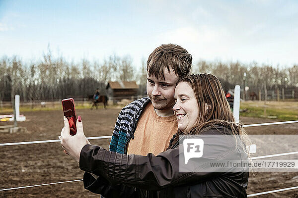 A mom with epilepsy taking a self-portrait with her son who has Aspberger Syndrome at an equine centre; Westlock  Alberta  Canada